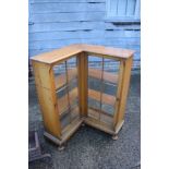 A 1930s oak corner 'L' shaped bookcase/display cabinet enclosed lattice glazed doors, 28" wide x