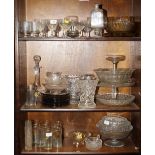 An assortment of glassware, including pedestal glasses, cut glass bowls, a decanter, eleven smokey