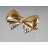 An 18ct gold 'bow' brooch set diamonds, 10ct approx, 5.3g gross