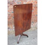 A George IV mahogany rectangular tilt top occasional table, on faceted column and tripod splay
