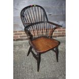 A 19th century black painted ash, beech and elm panel seat stick back elbow hair, on turned and