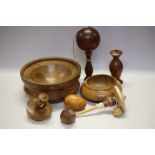 A turned oak spinning top, an apple and oak spinning top and other treen