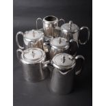 An assortment of silver plate, including two teapots, two coffee pots, one hot water pot and one