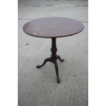 A Georgian mahogany circular tilt top table with birdcage, on turned column and tripod splay