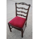 A Georgian carved mahogany ladder back dining chair of Chippendale design with drop-in seat, on