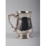 A Georgian silver pint tankard with scrolled handle, 10.5oz troy approx