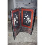 A Japanese lacquered two-fold screen with bone and mother-of-pearl inlaid panels (some losses),