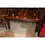 A William IV period mahogany extending dining table with centre leaf, on turned and reeded supports,