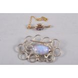 A white metal and opaline mounted brooch, and yellow metal, amethyst and seed pearl brooch