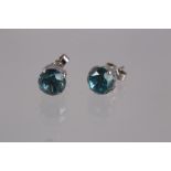 A pair of 9ct white gold and blue zircon ear studs