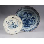 A Delft blue and white charger with building and central tree decoration, 13 1/2" dia (cracked), and