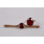 A 9ct gold and garnet single stone dress ring, size O, 5.2g, and a similar bar brooch, 2.2g