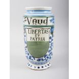 A majolica albarello inscribed "St Vaud" and "Libertas et Patria", 3 1/2" high (rim chip)