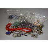 An assortment of beads for necklaces, white metal decorative items, etc