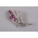 An 18ct white gold, ruby and diamond floral spray brooch, 8.2g