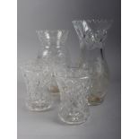 A pair of cut glass waisted vases, 5 1/4" high, a larger similar vase and one other