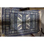 A pair of Tunisian blue garden pattern rugs, 39" x 21" approx, and a similar rug, 43" x 25" approx