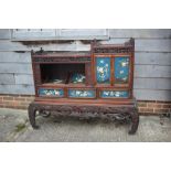 A late 19th century Japanese carved hardwood lacquered and bone inlaid cabinet, fitted sliding
