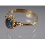 A yellow metal ring set oval mixed cut Sri Lankan sapphire with collar of diamonds, sapphire .9ct