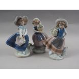 Three Lladro china figures of girls with baskets of flowers, largest 7" high