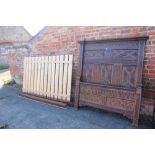 A carved oak bed of 17th century design with gothic panels, on stile supports, 59" wide x 82" long