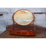 A 19th century mahogany and satinwood banded bowfront swing frame toilet mirror, fitted three