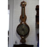 A 19th century banjo barometer with silvered dial, in rosewood case, 40" high