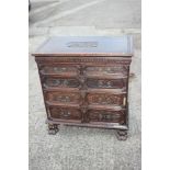 A 19th century carved oak chest of Restoration design, fitted two short and three long graduated