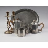A Harrods early 20th century hammered pewter four-piece teaset and a similar Arts & Crafts oval