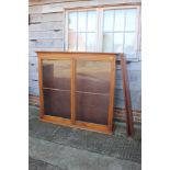 A late 19th century walnut bookcase, the glazed upper section enclosed two doors over two drawers