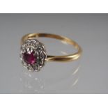 An 18ct gold dress ring set central ruby, .32ct approx, and collar of diamonds, 3g gross, size 0 1/2