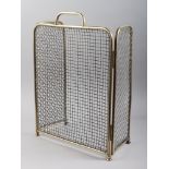 An early 20th century brass wirework three-fold firescreen, 15" wide