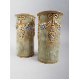 A pair of Royal Doulton spill vases, decorated relief swags