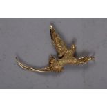 An Astwood Dickinson brooch/pendant, stamped 18ct, in the form of a bird of paradise with diamond
