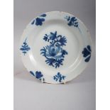 An 18th century blue and white English delft plate with floral decoration, 7 3/4" dia