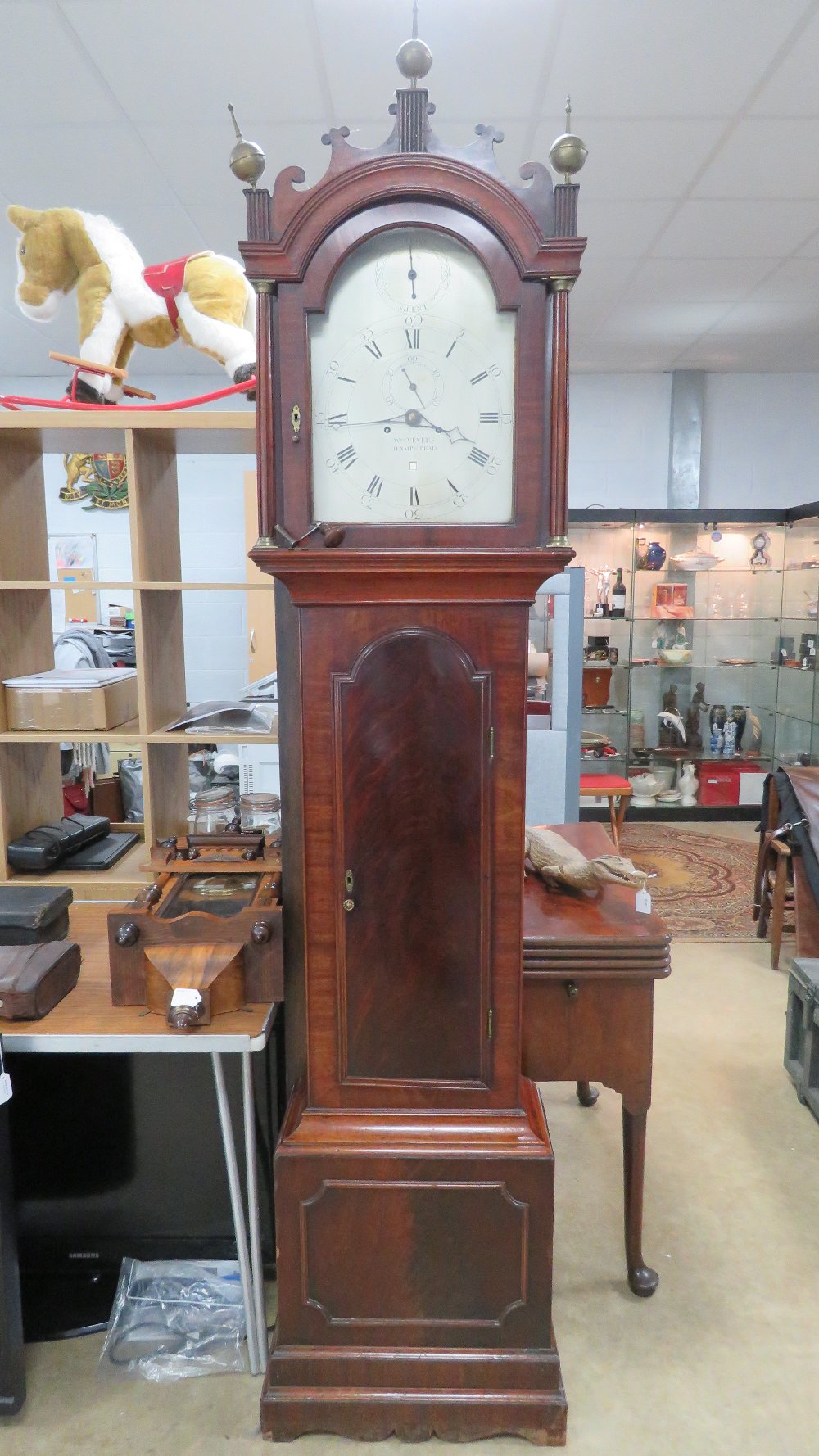 An eight-day striking long case clock.