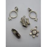 A HM silver charm in the form of a daisy together with other silver charms including woodpecker,