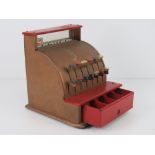 A vintage metal toy till having pop-up prices and cash drawer.