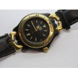 A Tag Heuer wristwatch having gold plated bezel with black dial, date aperture, black leather strap.