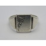 A HM silver mens signet ring having central unengraved square shaped panel with foliate decoration