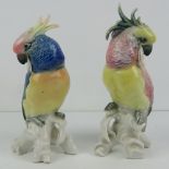 A pair of German made ceramic Cockatiels each measuring 18cm in hight, one a/f.