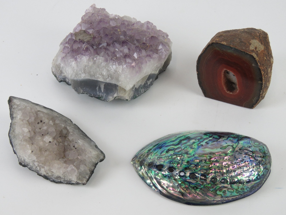 Three geodes together with an abalone shell. Four items.