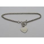 A charm bracelet having T-bar clasp and heart charm upon, stamped 925.