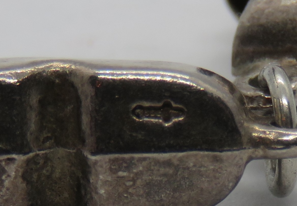 A silver charm in the form of a pair of clogs, silver hallmark upon (830?). - Image 2 of 2