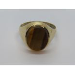 A mens signet style ring having large central tigers eye, uncarved, hallmark indistinct, size R, 4.