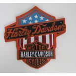 A contemporary cast metal Harley Davidson sign.