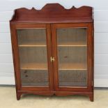 An Edwardian glazed double door bookshelf having shelves within, 83 x 23 x 96cm.