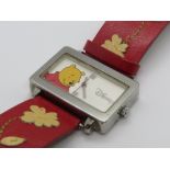 A Disney Winnie the Pooh watch on leather strap.