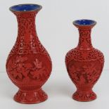 A graduated pair of Chinese carved red cinnabar and blue enamel vases, 15.