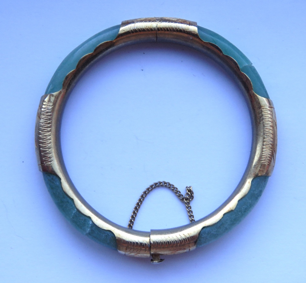 A jade bangle with gilt metal fittings, slightly a/f, 7.5cm ext dia, 6cm int dia. - Image 2 of 3